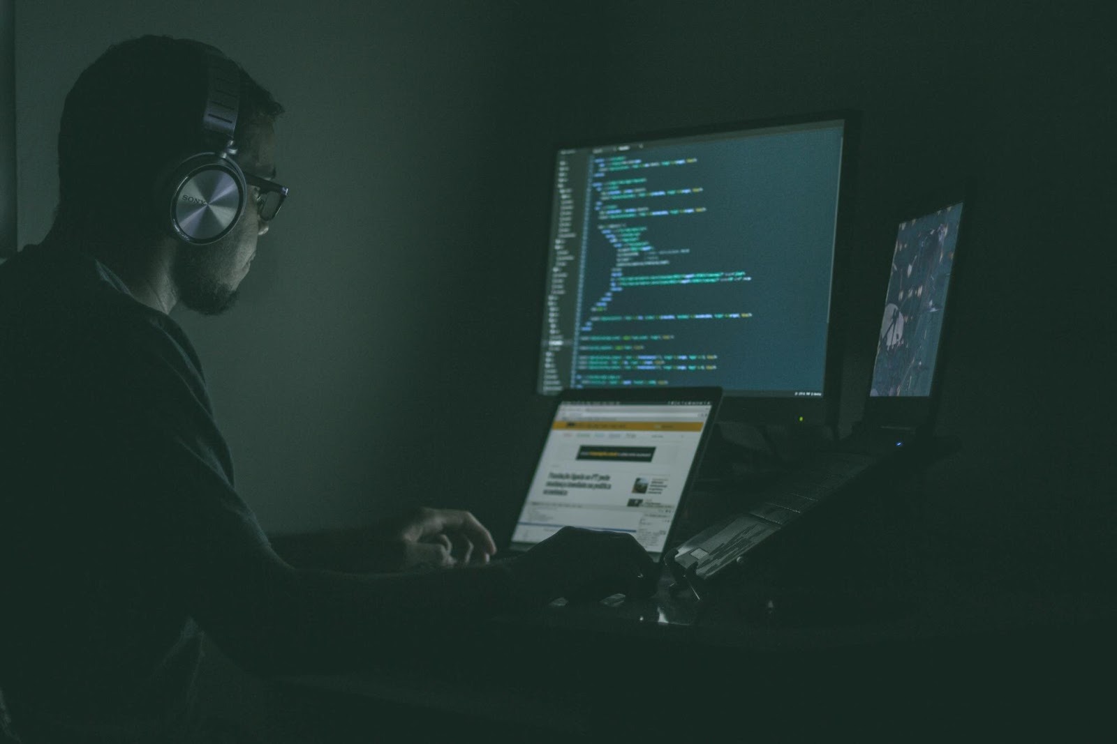 Digital strategist working on multiple screens in a dark room, analyzing complex data to optimize marketing campaigns.